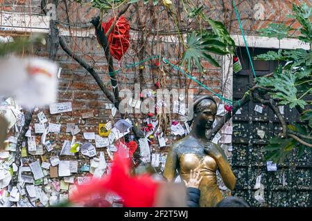 Verona - Italy. January 6, 2019: Statue of Juliet (symbol of love and romance) and wall with love notes in her house backyard in Verona Stock Photo