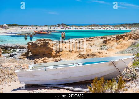View of one of the many beaches of the island of Formentera (in the foreground a white fishing boat) Spain Stock Photo