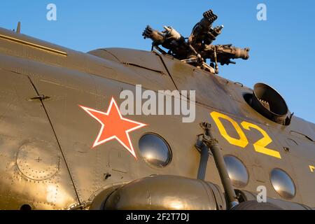 view of the red star on the hull of an old Soviet helicopter against the background of the engine and rotor with the blades removed Stock Photo