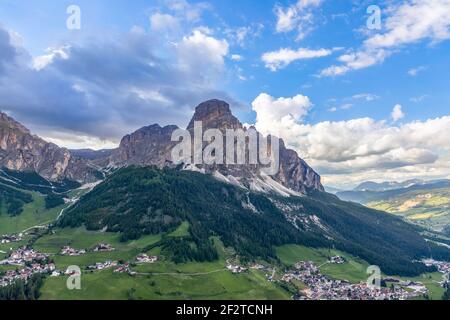 View of the alpine villages of Colfosco and Corvara at the foot of the mountain Sassongher. Italian Dolomites Stock Photo