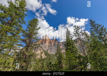 Peaks of the Italian Dolomites against the background of blue sky and stacked clouds Stock Photo