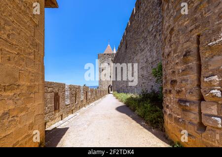 Wide fortified walls with walkways and arches of medieval castle of Carcassonne town Stock Photo