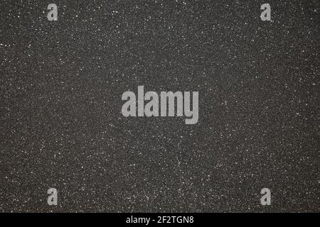 Black texture with micro-relief and glitter. Black glitter texture Stock Photo