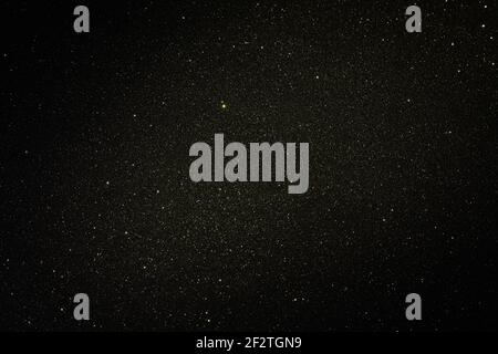 Black texture with micro-relief and glitter. Black glitter texture with illuminated center Stock Photo