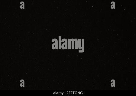 Black texture with micro-relief and glitter similar to the night sky with stars Stock Photo