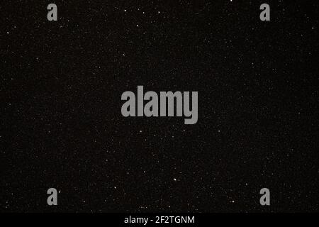 Black texture with micro-relief and glitter similar to the night sky with stars Stock Photo