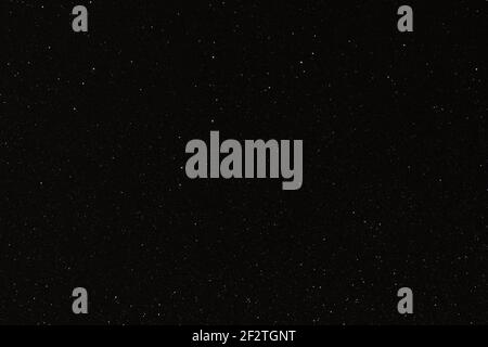 Black texture with micro-relief and glitter similar to the night sky with stars Stock Photo