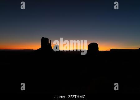 Silhouette photo of famous Buttes at the first rays of dawn light of Monument Valley on the border between Arizona and Utah, USA Stock Photo