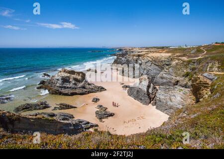 Holidaymakers walking by the words 'Amo-te' ('I love you' in Portuguese), drawn in the fine sand of a wild beach in Porto Covo,  Alentejo - Portugal. Stock Photo