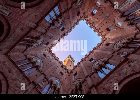 View from the courtyard of Palazzo Pubblico to the Torre del Mangia. Siena, Tuscany, Italy Stock Photo