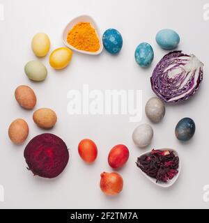 Natural dye for easter eggs - red cabbage, beetroot, carcade, turmeric and onion skin on light background Stock Photo