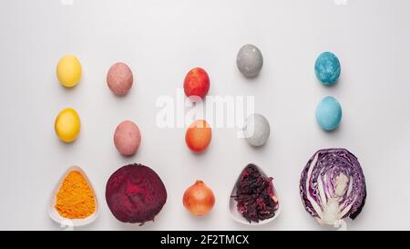Natural dye for easter eggs - red cabbage, beetroot, carcade, turmeric and onion skin on light background Stock Photo