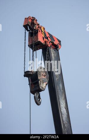 Truck crane boom with hooks on blue sky Stock Photo