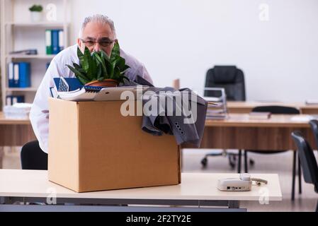 Old employee being fired from his work Stock Photo