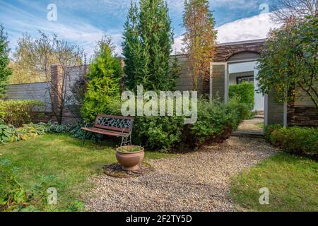 element of landscape design - mirror in the wall o garden - creating the illusion of transition into another space don't existing.  Garden near dacha Stock Photo