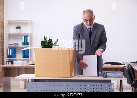 Old employee being fired from his work Stock Photo