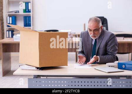 Old employee being fired from his work Stock Photo