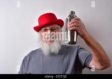 A cheerful American pensioner posing with a cocktail shaker Stock Photo