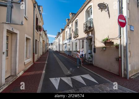 Two ladies walking down an otherwise deserted street. Stock Photo