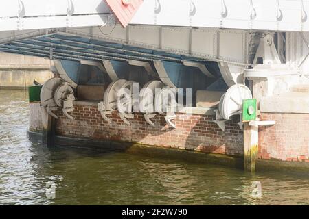 Mechanism of drawbridge across river. Bottom view of gears and lift structure. Stock Photo