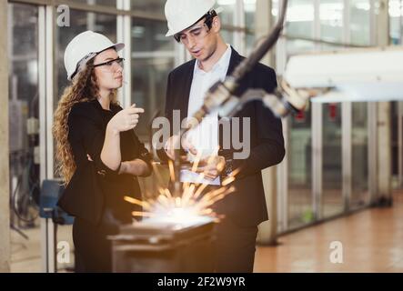 Engineer with digital tablet supervising autonomous producton process Stock Photo