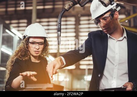 Engineer with digital tablet supervising autonomous producton process Stock Photo