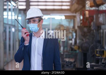Factory engineer talking on walkie talkie transmitter Stock Photo