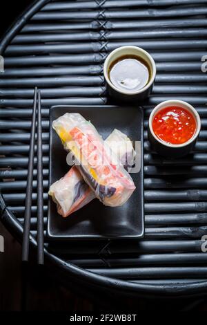 Fresh spring rolls with sweet and sour sauce. Vietnamese cuisine. Stock Photo