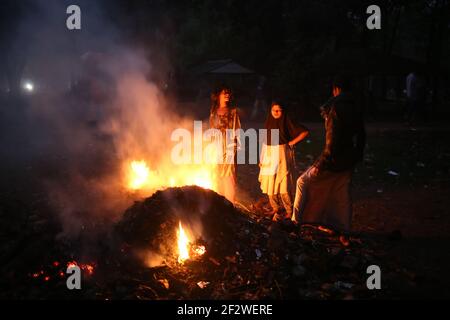 Dhaka, Bangladesh. 13th Mar, 2021. Dried leaves are being burnt to clear the park at the Suhrawardi Uddan as Amar Ekushey Book Fair 2021 is going to start in a few days.This year the book fair is starting late due to the novel coronavirus.Burning of leaves leads to air pollution, health problems and fire hazards. Credit: Md. Rakibul Hasan/ZUMA Wire/Alamy Live News Stock Photo