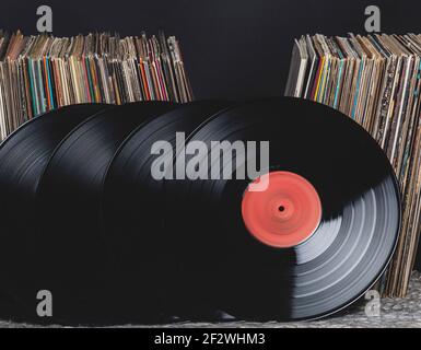 four records lean against a pile of records Stock Photo