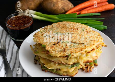 Pajeon (Korean Potato Pancakes) with Dipping Sauce: Savory vegetable pancakes with a sesame-soy dipping sauce Stock Photo