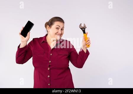 Repair and service mobile phones concept. Smartphone, businesswoman boss and repair tools. Repair a broken gadget. Worker talk and work. Trendy Stock Photo