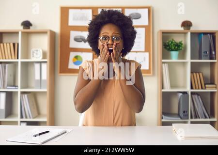 Shocked african american woman showing surprise wow expression looking at camera Stock Photo