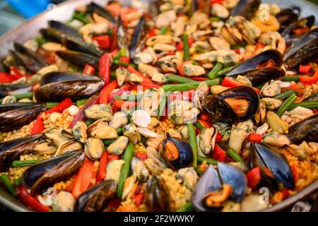 Paella being prepared on improvised stove. Stock Photo