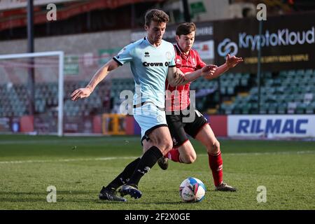 LINCOLN, UK. MARCH 13TH: Conor Shaughnessy of Rochdale and Conor McGrandles of Lincoln City battle for possession during the Sky Bet League 1 match between Lincoln City and Rochdale at LNER Stadium, Lincoln on Saturday 13th March 2021. (Credit: James Holyoak | MI News) Credit: MI News & Sport /Alamy Live News Stock Photo