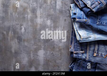 Denim jeans on old abstract background texture of table surface Stock Photo