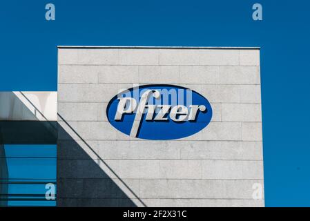 Madrid, Spain - March 13, 2021: Pfizer logo on Pfizer building. Pfizer is an American pharmaceutical corporation Stock Photo