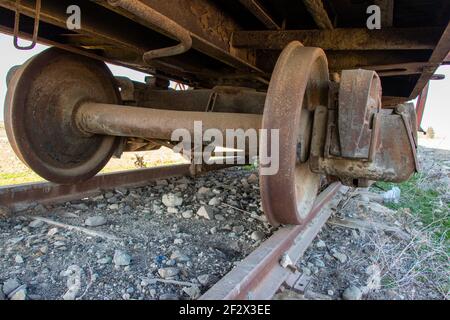 Closeup of the old rusty train wheels. Details of the wheel of train. Stock Photo