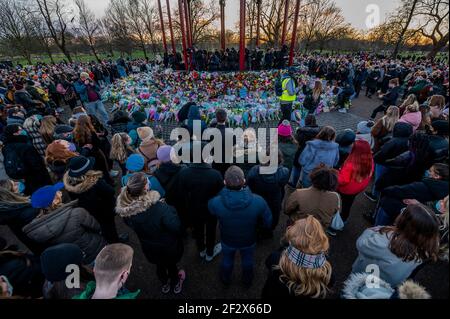 London, UK. 13th Mar, 2021. People gather to leave flowers and tributes for Sarah Everard at a vigil at the Bandstand where planned. Despite it being banned by the police under covid regulations. She disappeared after 9:00 on March 3 somewhere between Clapham Junction and Brixton. Credit: Guy Bell/Alamy Live News