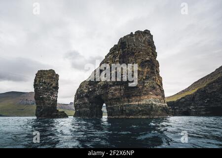 Drangarnir is the collective name for two sea stacks between the islet Tindholmur and the island Vagar in the Faroe Islands. Stock Photo