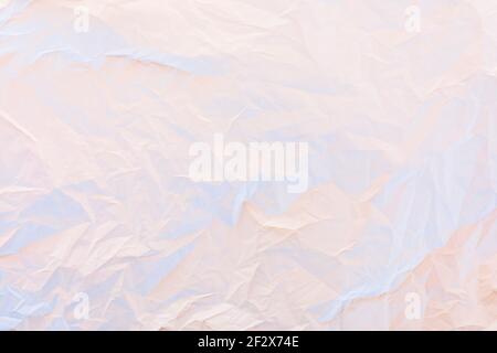 Crumpled paper in pastel pink and blue neon lights texture background Stock Photo