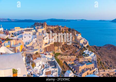 Sunset view of Oia with castle of Oia at Santorini island, Greece Stock Photo