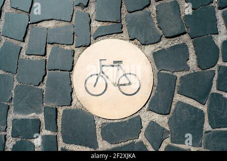 Bicycle sign on the old stone road in centre of Lisbon. Road for bicycles Stock Photo