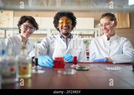 Young chemistry students have fun working with chemicals in a cheerful atmosphere in the university laboratory. Science, chemistry, lab, people Stock Photo