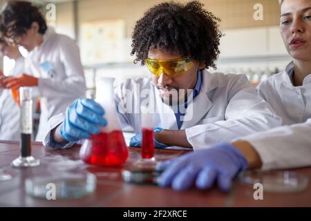 Medical students conducting chemical experiment in the lab Stock Photo