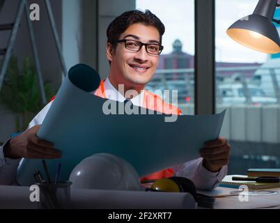 The construction architect working on drawings late at night Stock Photo
