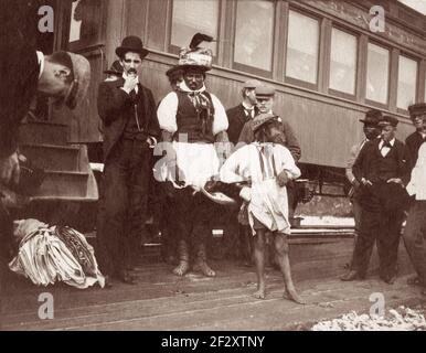 Billy Bowlegs III, aka Billy Fewell or Cofehapkee (1862–1965), Seminole elder (also of African American descent) and tribal historian, standing with other men beside a train in Ft. Pierce, Florida, in 1896. Bowlegs was the grandson of Osceola and was a member of the Snake Clan. Stock Photo