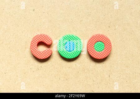 Foam alphabet letter in word COO (abbreviation Chief operating officer) on wood background Stock Photo