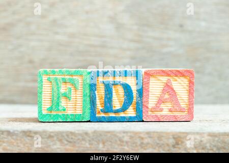 Color alphabet letter block in word FDA (abbreviation of food and drug administration) on wood background Stock Photo