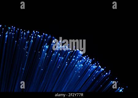 perfectly focused arc shaped blue fiber optic lights on black background Stock Photo
